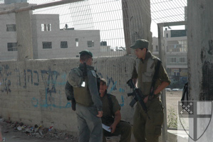 [Israeli soldiers guard a...]